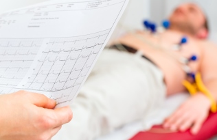 man lying on bed having an ECG