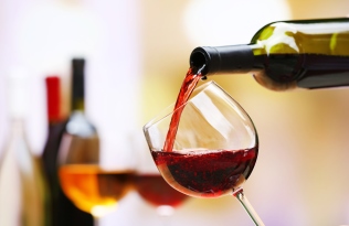 red wine being poured into a glass