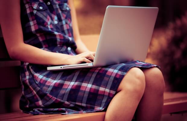 A woman typing on a laptop