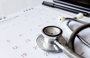 GP stethoscope and calendar planning appointments