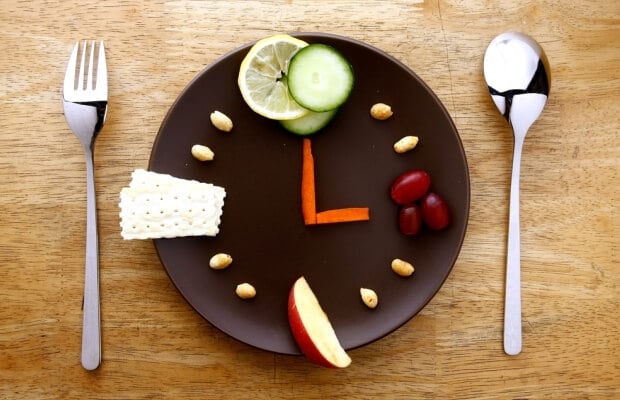 Healthy snacks on a plate marking out a clock