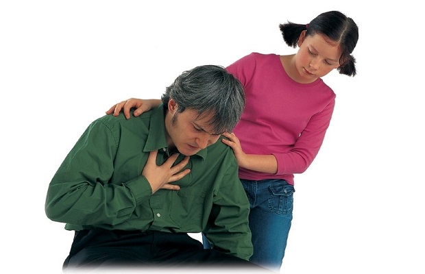 A man kneeling down clutching his chest, with a girl standing holding his shoulders