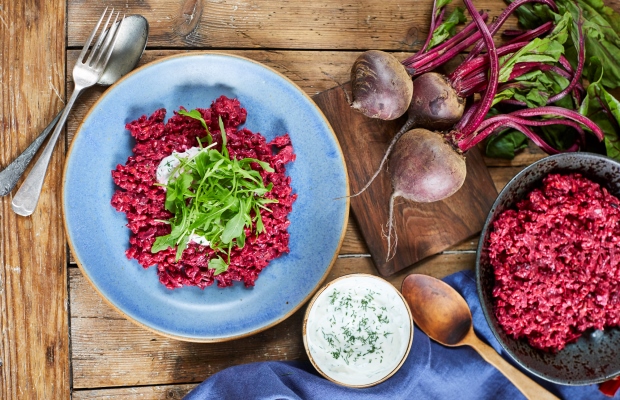 A plate of barley risotto with a side of yoghurt dip