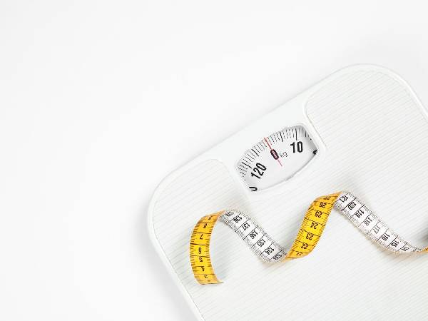 weighing scales with a tape measure lying on top of the scales