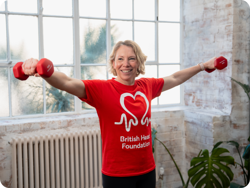 Becky Fuller lifting weights while wearing a BHF T-shirt.