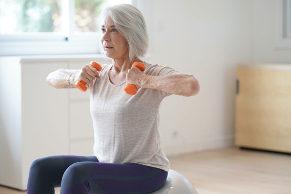 Woman exercising using hand weights