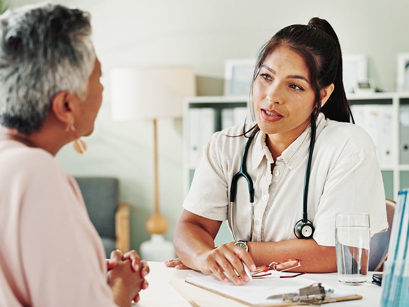 A clinician consults a patient in the office.