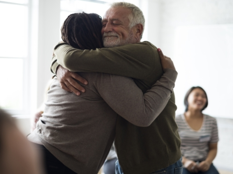 Two people hugging each other