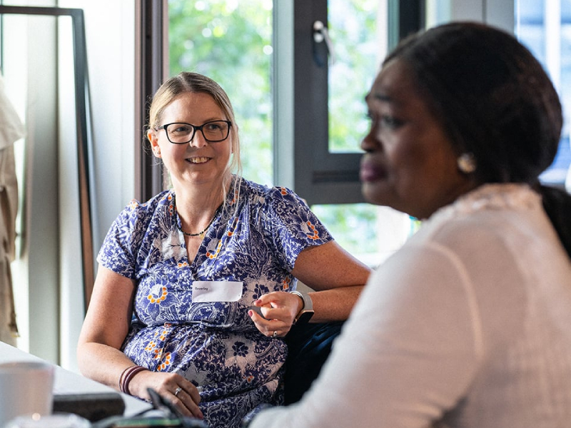 Two women sat down having a conversation