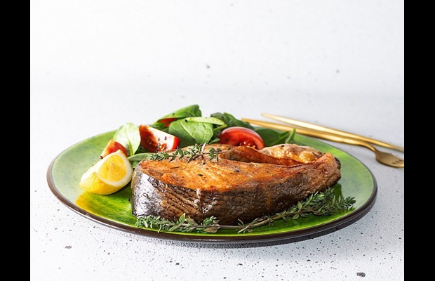 Oven-baked salmon on a plate with vegetables