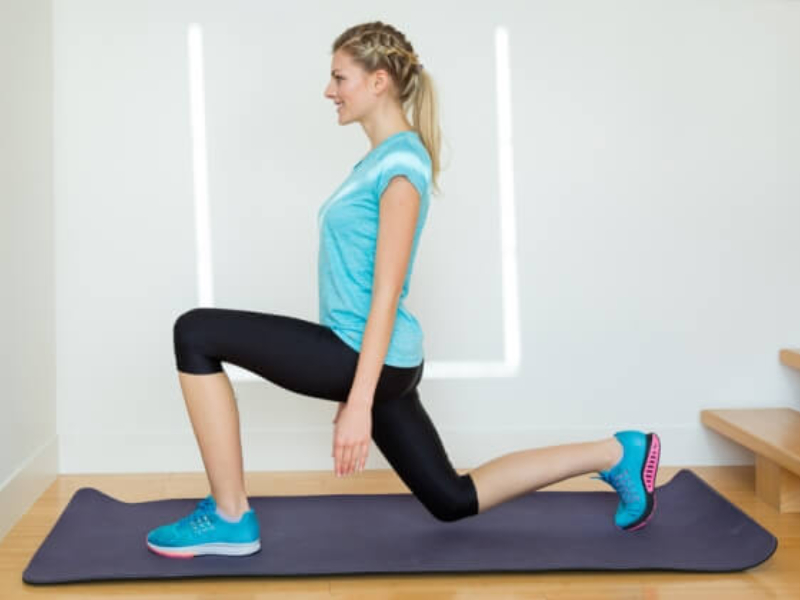 A woman holding an exercise position on a mat