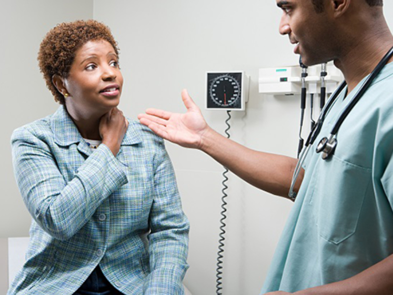 A doctor speaking to a patient in a hospital