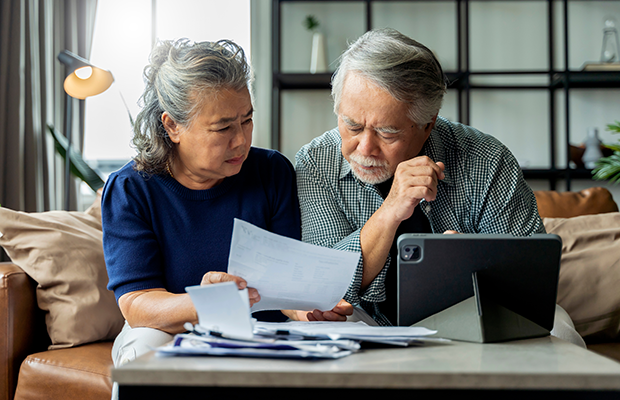Elderly couple looking at bills