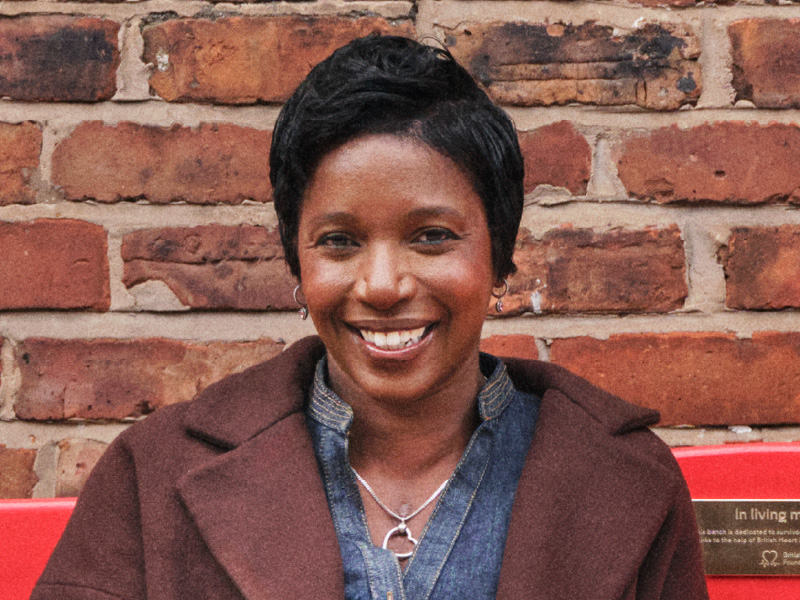 Michelle sat on a red bench smiling