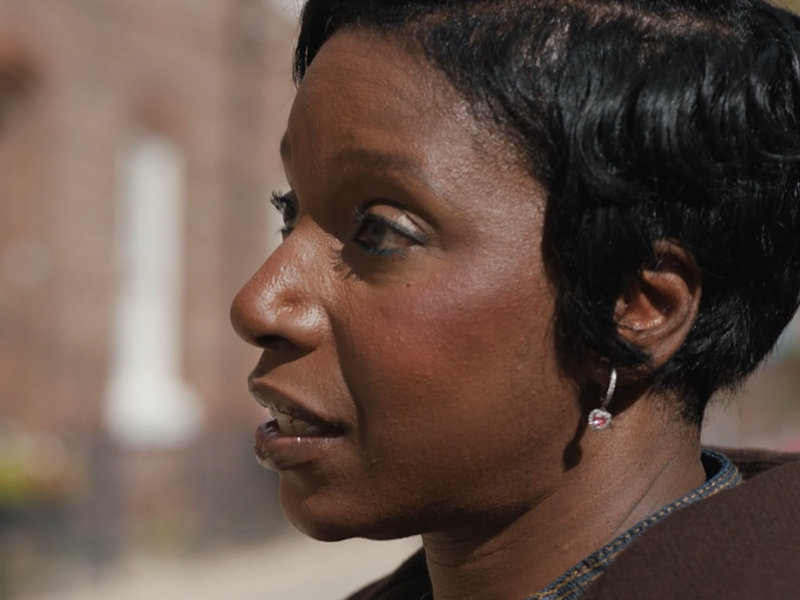 Michelle sat on a red bench talking about her story