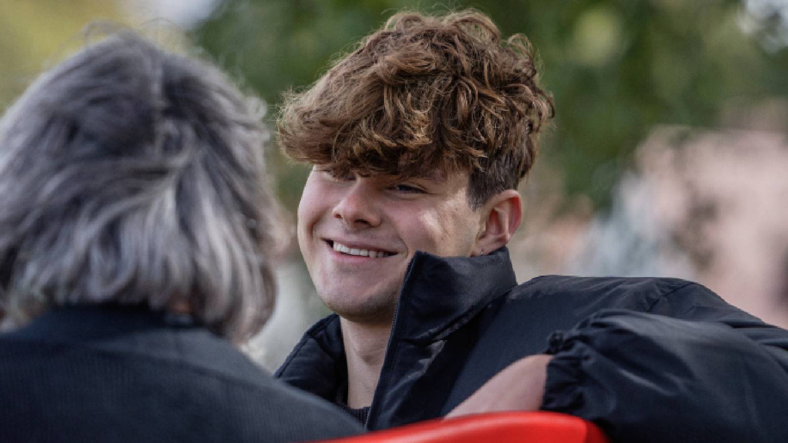An image of Jack, one of our living proof stories, sat on our red benches