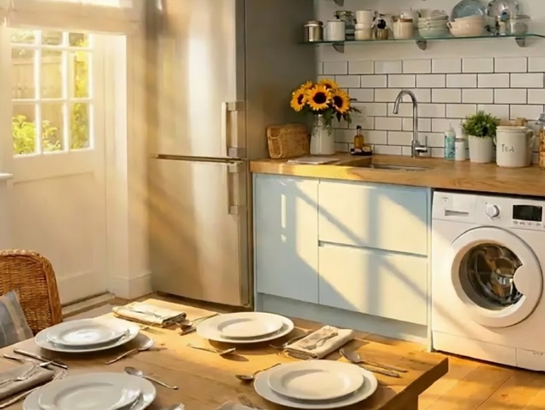 A sunlit kitchen with a wooden dining table at the centre of the room.