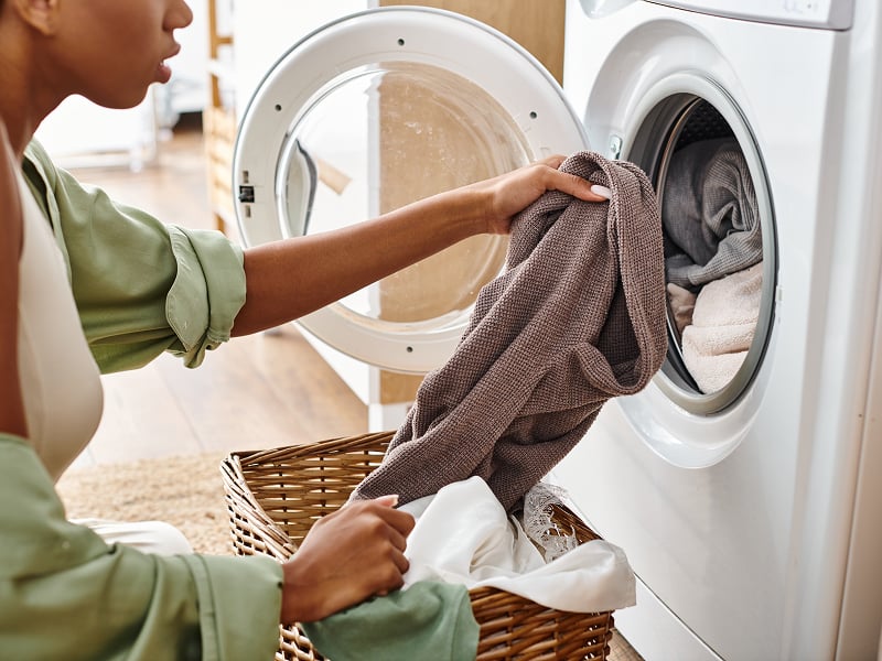 Person taking laundry out of washing machine