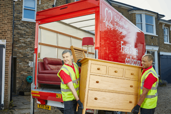BHF staff clearing house items into BHF van