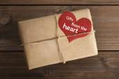 Parcel wrapped in brown paper with heart-shaped tag labelled 'Gifts from the heart'
