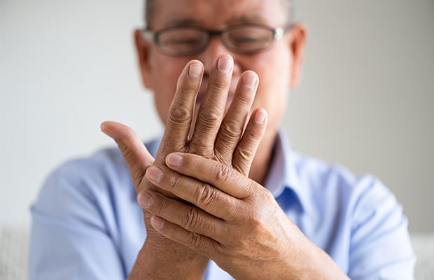 Man with poor circulation looking at hands