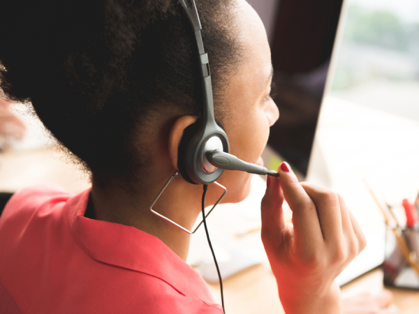 A cardiac nurse wearing a headset speaks to a caller on the Heart Helpline.