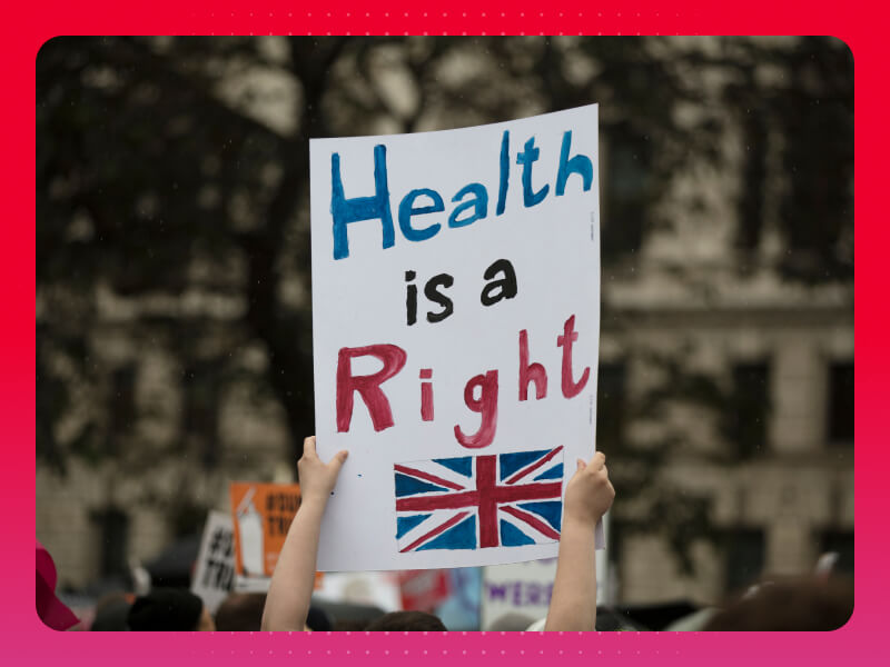 Sign reading "Health is a right" with a union jack drawing underneath