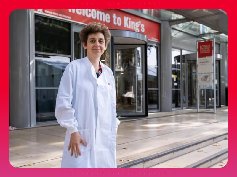BHF researcher in white lab coat standing outside a King's College