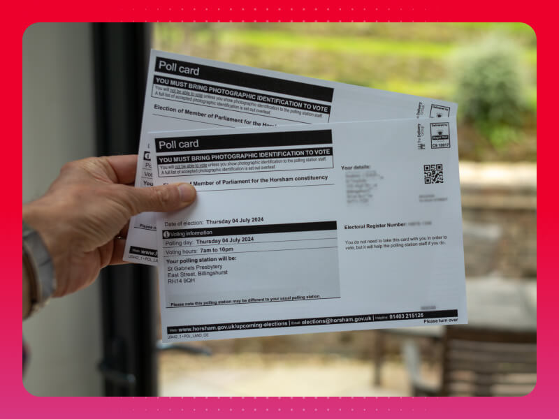 Hand holding 2 polling station cards