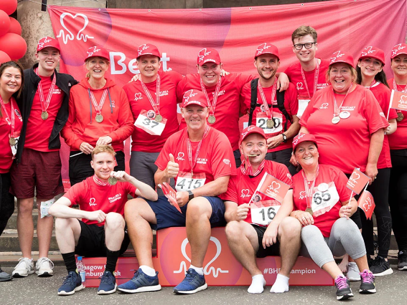 A group of people wearing BHF branded t-shirts together smiling