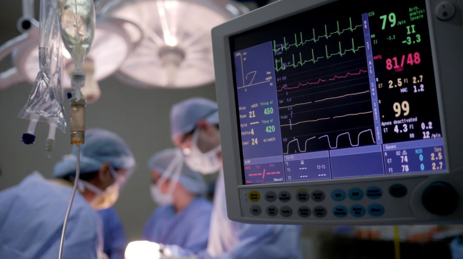 surgical screen with surgeons in the background