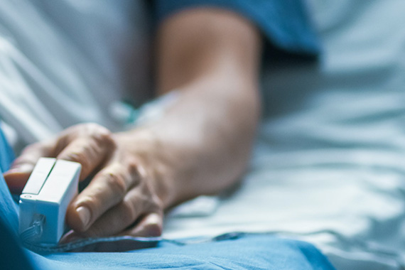 A person's arm is shown in a hospital bed