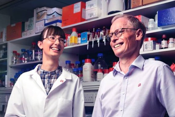 Professor Hugh Watkins and Professor Christine Seidman stood in a lab
