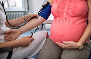 pregnant woman checking blood pressure