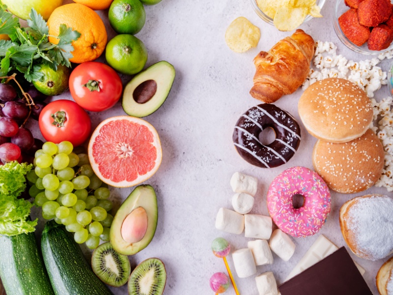 healthy foods like avocado, grapes and grapefruit on the left and donuts, cakes and croissants on the right side