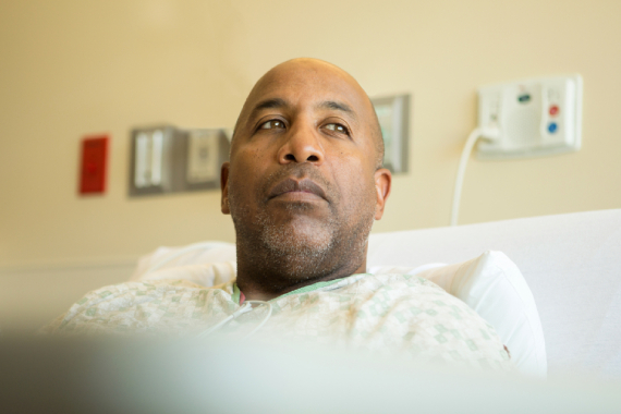 Man sits in a hospital bed