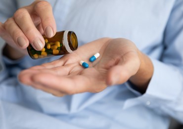 Hands holding some pills