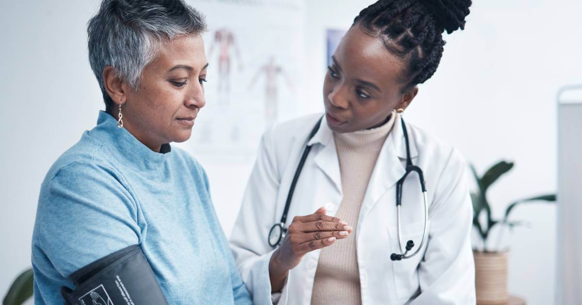 Doctor taking patient's blood pressure