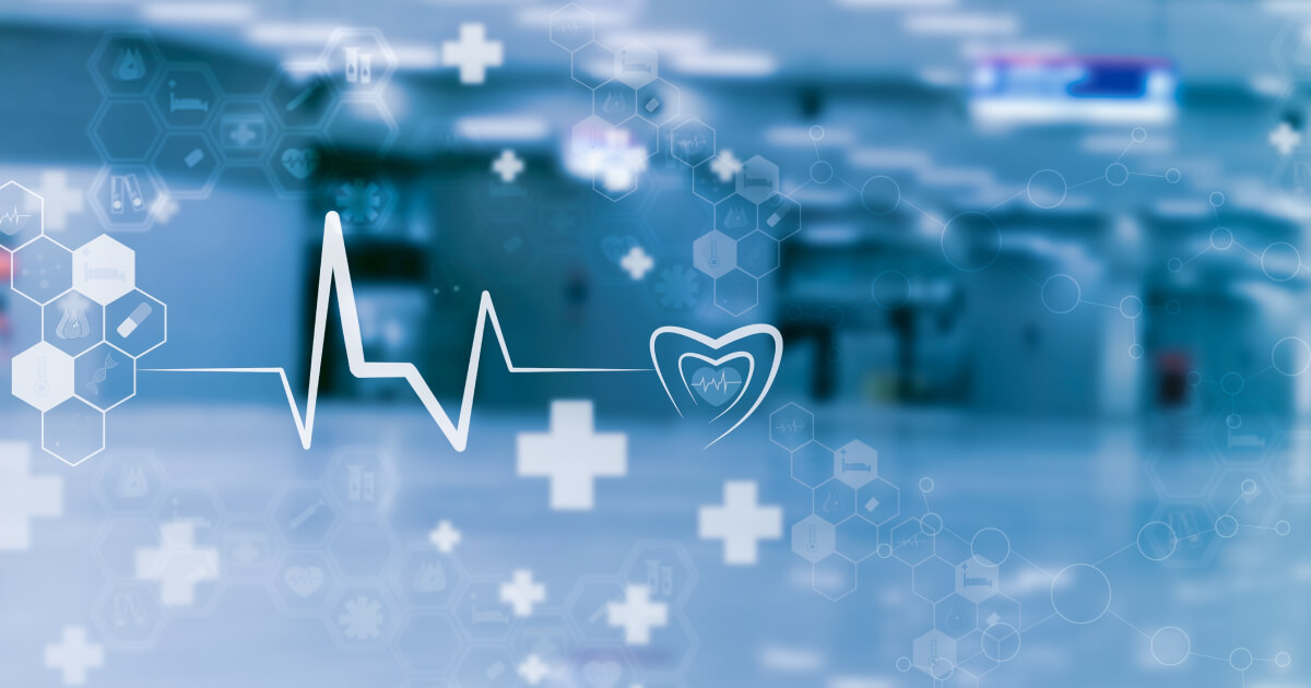 Digital image showing an echocardiogram and medical cross and hexagon patterns over a blurred image of a healthcare setting