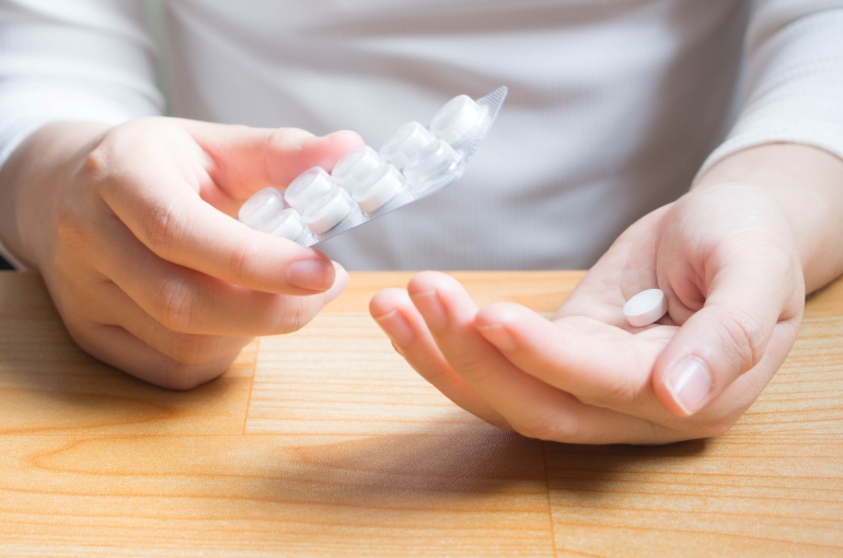 hands holding pills
