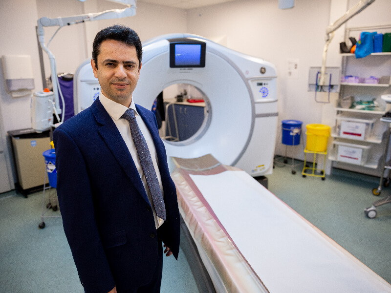 BHF Researcher stands in front of an MRI machine