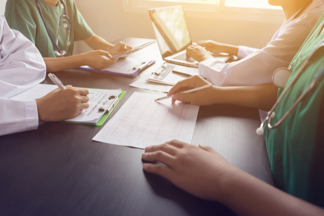 Doctors collaborating using patient information