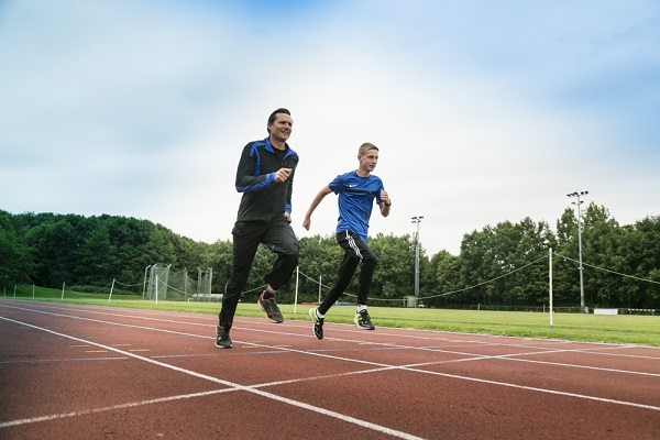 Roger Black and Luke Ball running on an athletics track