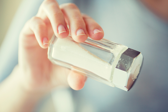Someone pouring salt