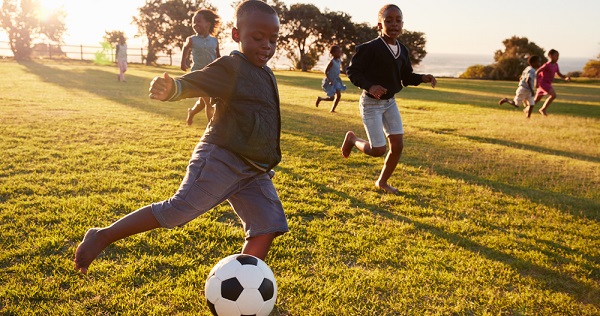 School children playing football 