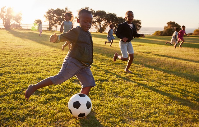School children playing football