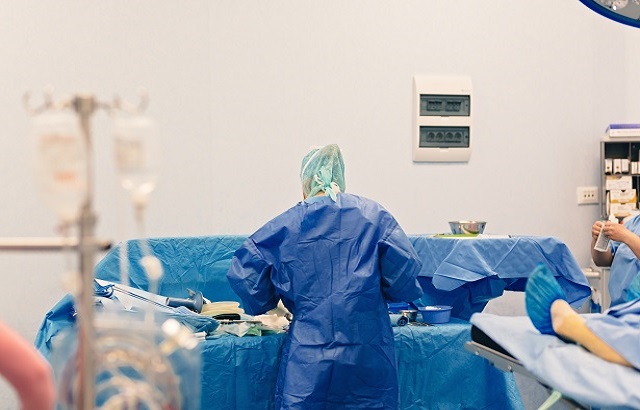 Cardiologist performing a procedure that is commonly used to treat patients with aortic stenosis