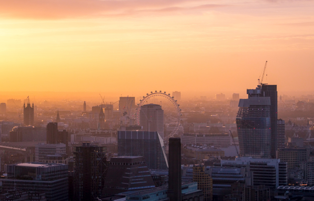 London cityscape at sunrise with the London Eye in the centre.