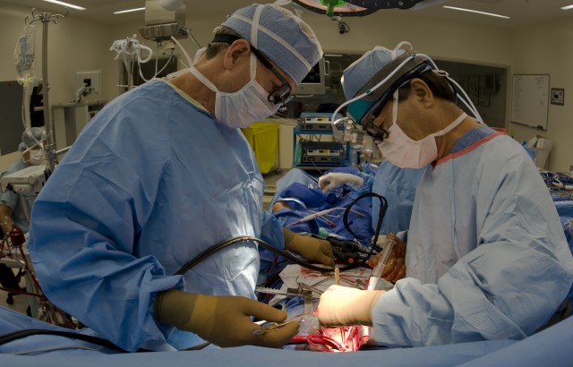 Surgeons performing open heart surgery in an operation room