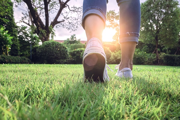 image of a person walking on grass
